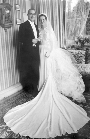 Couple de mariés souriant, posant debout dans un salon (même cliché que 51 Fi 520) : tirage papier en noir et blanc 11,3x17,5 cm.