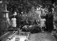 Autour d'une tombe même famille rassemblée, avec chapeaux pour les dames et fillettes.